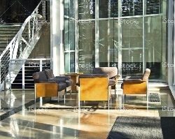 Seating area inside a commercial building with sunlight shining through the windows.